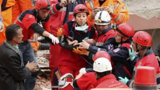 A baby is rescued from the rubble