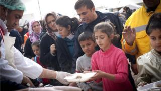 A girl receives food after the earthquake.