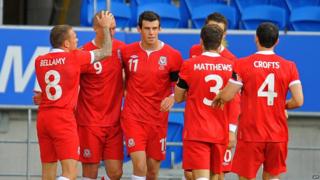 Welsh players celebrate scoring against Norway