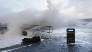 Waves crash against the promenade in Largs, Scotland