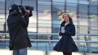 Hayley and cameraman outside office