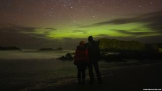 Couple posing in front of Aurora