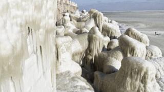 Stones covered in ice by the Black Sea near the shores of Romania