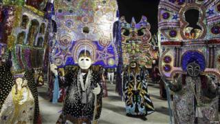 Dancers with glittery masks take part in the first night of the Rio carnival.