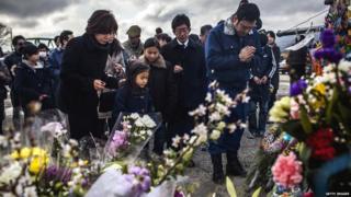 A family in Japan pay their respects to victims of the last years tsunami at a memorial