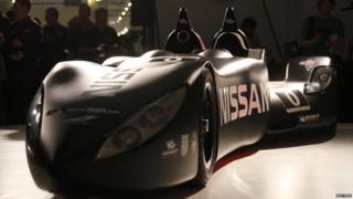 Nissan's new Deltawing race car is seen after it was unveiled in London. This frontal shot highlights the smooth shape of the car. Two driving seats at the back of the car stand tall, jutting out of the low vehicle.