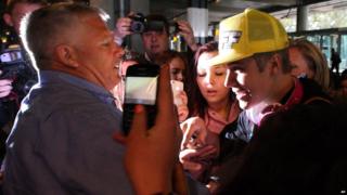 Justin Bieber mobbed by fans at London's Heathrow Airport