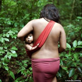 Awa woman carring a baby in a sling