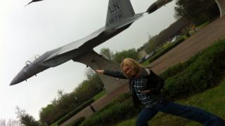 Hayley next to a statue of a jet