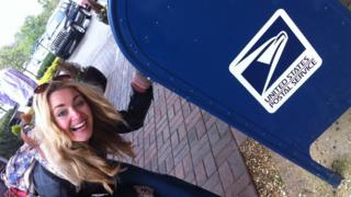 Hayley next to a U.S. post box