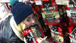 Hayley next to some beef jerky packets