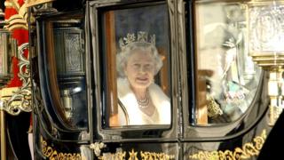 Queen Elizabeth II in a horse drawn carriage on route to the State opening of Parliament