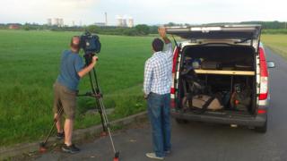 Joe and cameraman Marty film the Didcot Power Station towers in Oxfordshire.