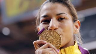 Brazil's Sarah Menezes gives her gold medal as kiss.