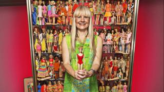 German woman posing with her award winning Barbie doll collection.