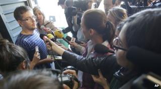 The editor of the French magazine answering questions from journalists