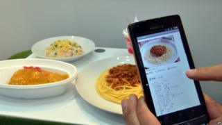 Mobile phone taking a picture of some food