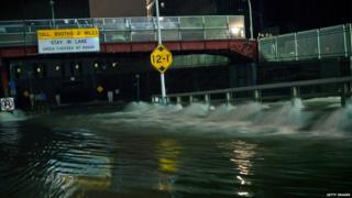 Flood water rushes into the entrance of the Carey tunnel, New York.