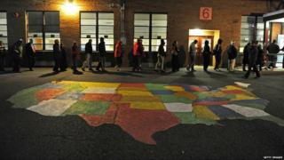 People enter Washington Mill Elementary School to cast their vote in Alexandria, Virginia