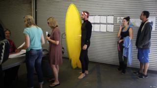 Surfer Mike Wegart, 30, waits to vote at Venice Beach lifeguard station in Los Angeles, California