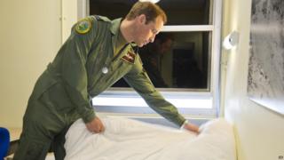 Prince William making his bed.