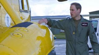 Prince William carrying out a check on his air craft.