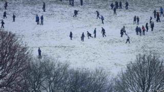 School children play in a snow covered field near Halifax