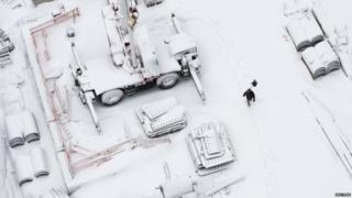 Man with shovel in snow.