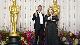 Adele and Paul Epworth pose with Oscars.