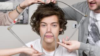 Harry from One Direction getting measured up for this Madame Tussauds waxwork