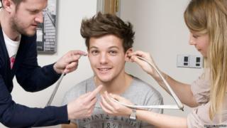 Louis from One Direction getting measured up for this Madame Tussauds waxwork