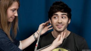Zayn from One Direction getting measured up for this Madame Tussauds waxwork