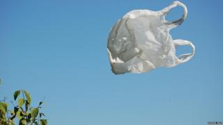 Plastic bag flying past a tree