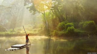Man standing on a water raft