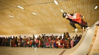 Girl skating in front of a crowd