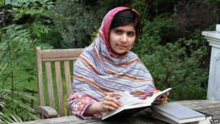 Malala Yousafzai at home reading a book in her garden