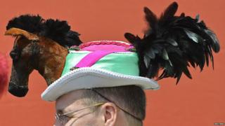 Man in a horse shaped hat at Ascot