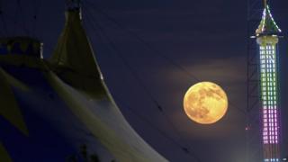 Supermoon over a fair ground in New Jersey, USA