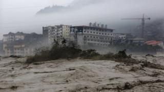 This picture taken on 9 July 2013 shows heavy flood waters sweeping through Beichuan in south-west China's Sichuan province