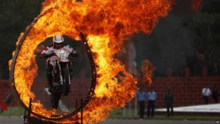 An Indian army soldier performs a motorcycle stunt