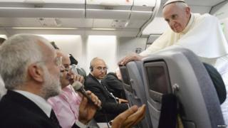 Pope Francis answers journalists' questions during a flight.