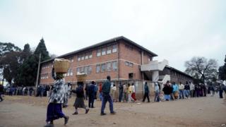Zimbabweans line up near a polling station