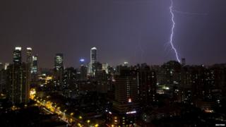 Lightning is seen above buildings during a storm in central Shanghai July 31, 2013