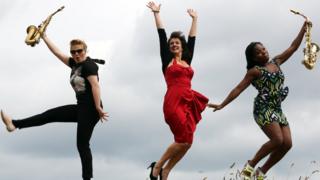 Jazz musicians jumping in the air in Edinburgh.