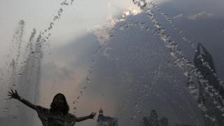 woman plays in fountain