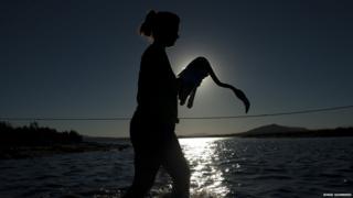 woman carrying flamingo