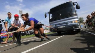 Woman pulling a bus