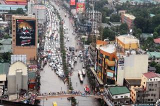 Heavy rain in the Philippine capital of Manila has turned the city's roads into rivers. Hundreds of cars queue to wait for the water to subside.