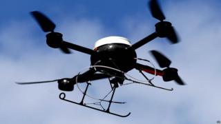 An aerial surveillance drone in Liverpool - it looks like a small helicopter.