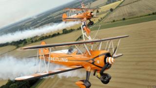 Nine-year-old cousins Rose (front) and Flame wingwalking over Rendcomb Airfield near Cirencester for the charity Duchenne Children's Trust, becoming the world's youngest formation wingwalkers.